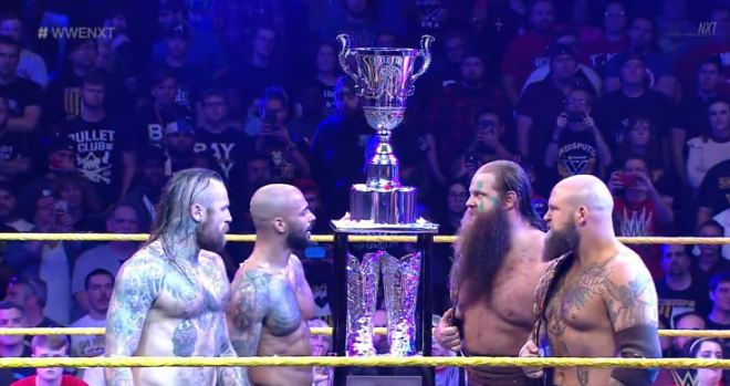 the DRTTClassic trophy stands prominently, center ring, as War Raiders and Ricochet & Aleister Black stare one another down on March 27th's nXt closing moments.