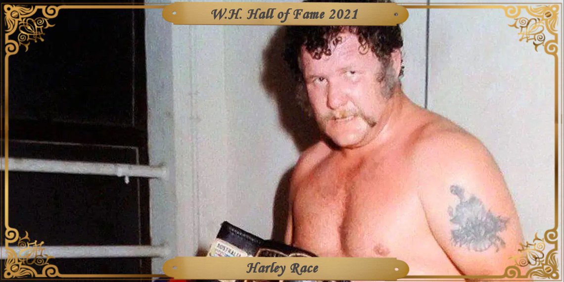 Race with his trademark sideburns and moustache, stares at the camera after a match, holding the NWA crown title.