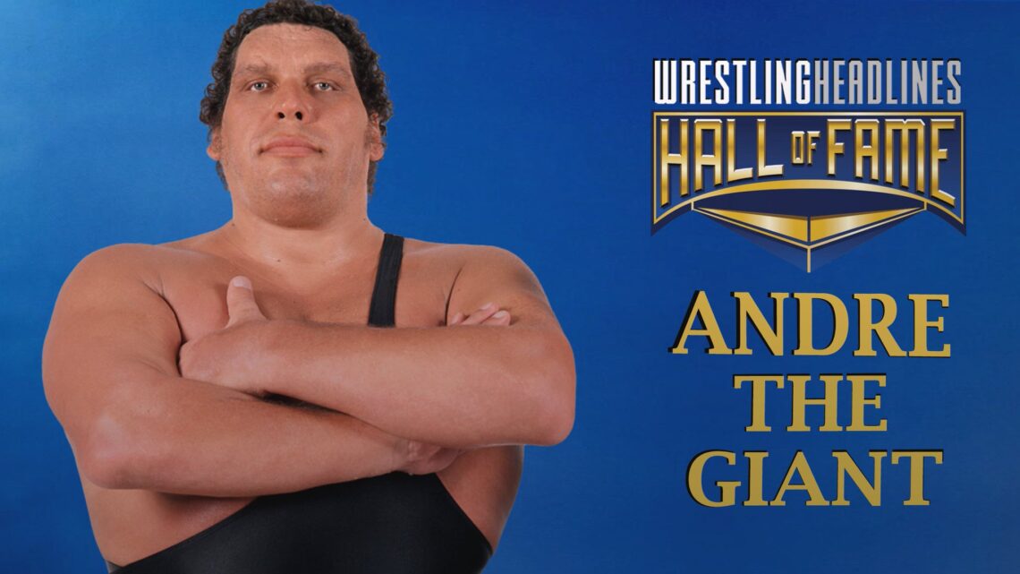 Andre stands tall, arms crossed over his chest, wearing his trademark one-shoulder strap black singlet.