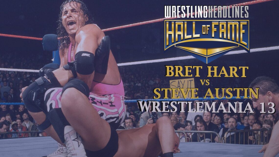 Bret Hart holds Austin in his signature Sharpshooter submission hold, mouth agape, hair in his face. Ken Shamrock, special guest referee looks on from right, only his head and arms visible.