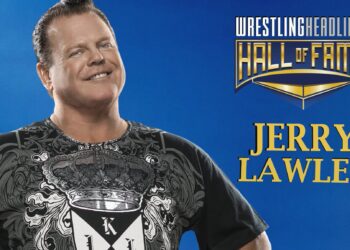 Jerry Lawler stands with a big smile on his face and his black and grey King t-shirt on.