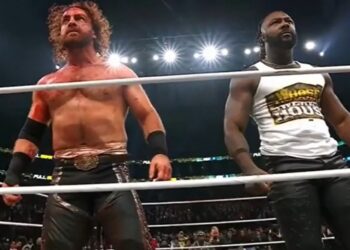 Rivals Hangman Page and Swerve Strickland stood side by side to fight off new champion Samoa Joe and the Opps. Page lost the AEW championship to Joe after Hook interfered during their steel cage main event at Full Gear 2025. | Source: AEW