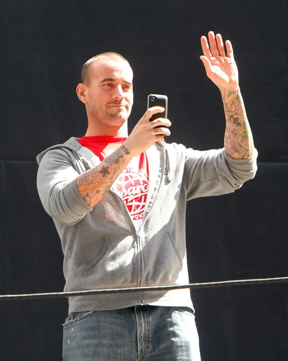 CM Punk Recreates Infamous NSFW Seth Rollins & Becky Lynch Photo, Immediately Goes Viral