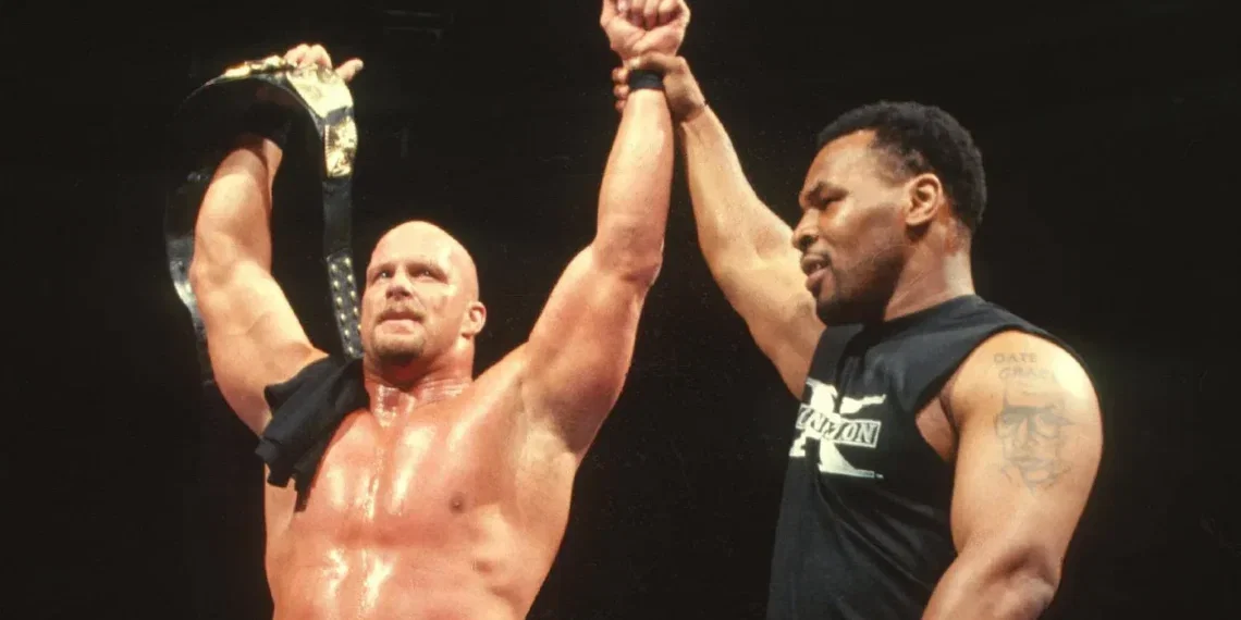 "Iron" Mike Tyson Raises "Stone Cold" Steve Austin's Hand In Victory After Austin Wins The WWF Championship At WrestleMania 14 | Source: WWE.com