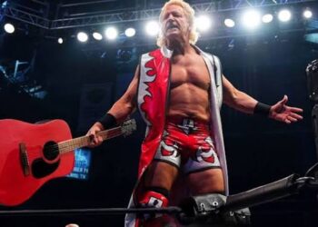 Jeff Jarrett holding his guitar in an AEW ring