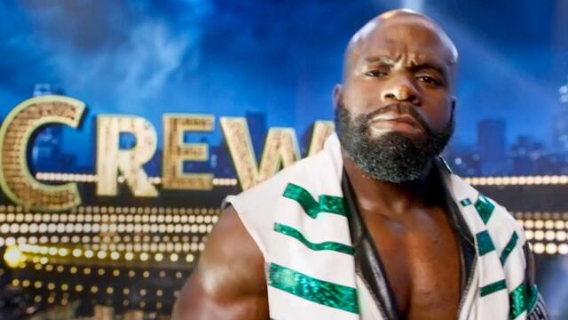 Apollo Crews in white and green WWE ring attire