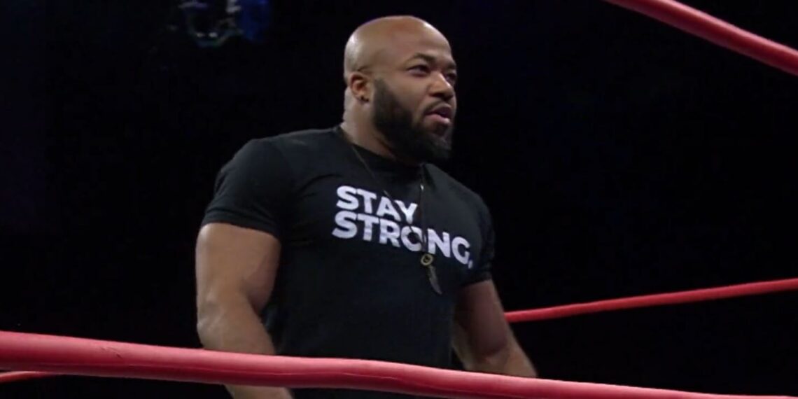 Jonathan Gresham standing in a wrestling ring