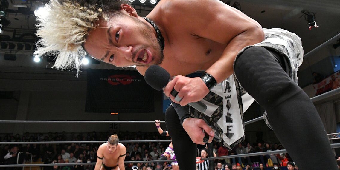 Kzy speaks inside a Dragon Gate wrestling ring