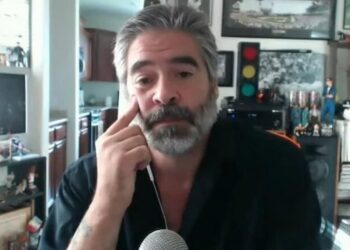 Vince Russo speaking at a microphone