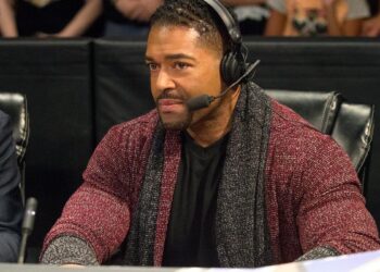 David Otunga wearing a headset at WWE commentary desk